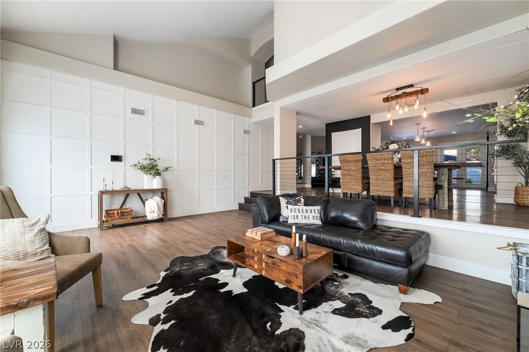 Dramatic vaulted ceilings and detailed paneling highlight this split-level interior space.