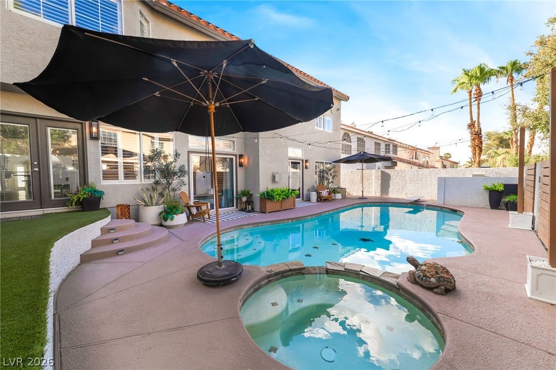 A sparkling swimming pool and integrated spa define this private backyard oasis.