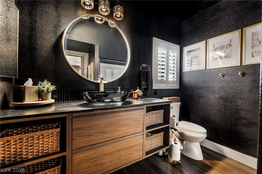 Dramatic dark textured walls complement a handsome wood vanity in this custom powder room.