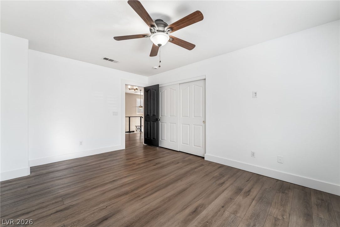 Rich wood-inspired flooring pairs beautifully with crisp white walls and classic molding.