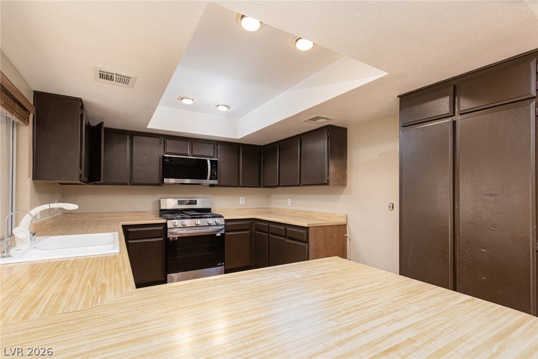737 Brick Drive, Henderson, NV 89002 Functional workspace layout integrates ample cabinetry with integrated lighting alcoves above.