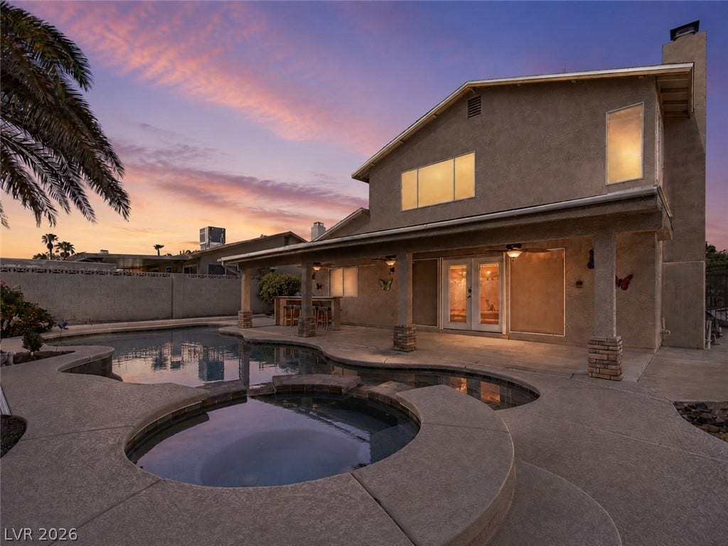 737 Brick Drive, Henderson, NV 89002 An inviting backyard oasis features a custom pool, spa, and a spacious covered patio.