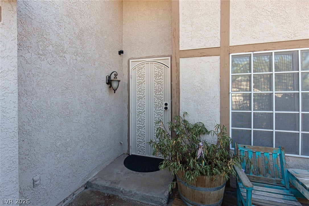 737 Brick Drive, Henderson, NV 89002 An inviting entrance welcomes with classic stucco finishes and a decorative security screen door.
