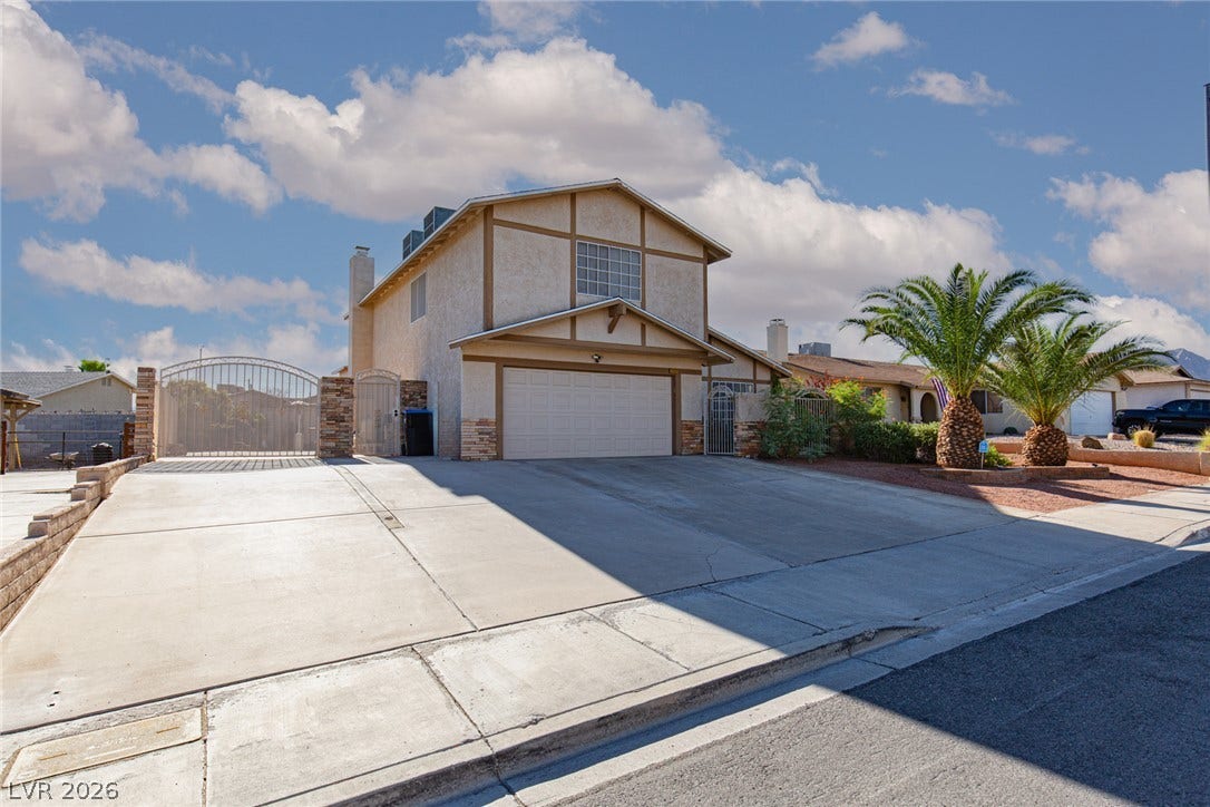 737 Brick Drive, Henderson, NV 89002 A spacious concrete driveway leads to the attached two-car garage of this multi-level home.