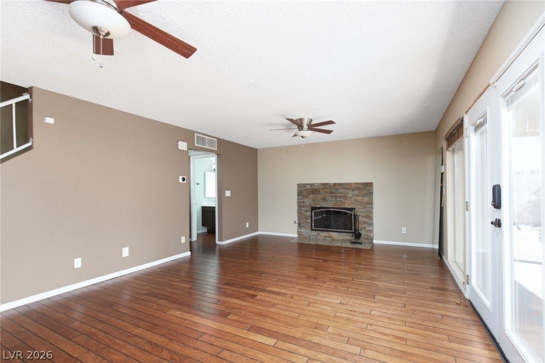 737 Brick Drive, Henderson, NV 89002 Rich wood floors anchor this inviting living space anchored by a stone fireplace.