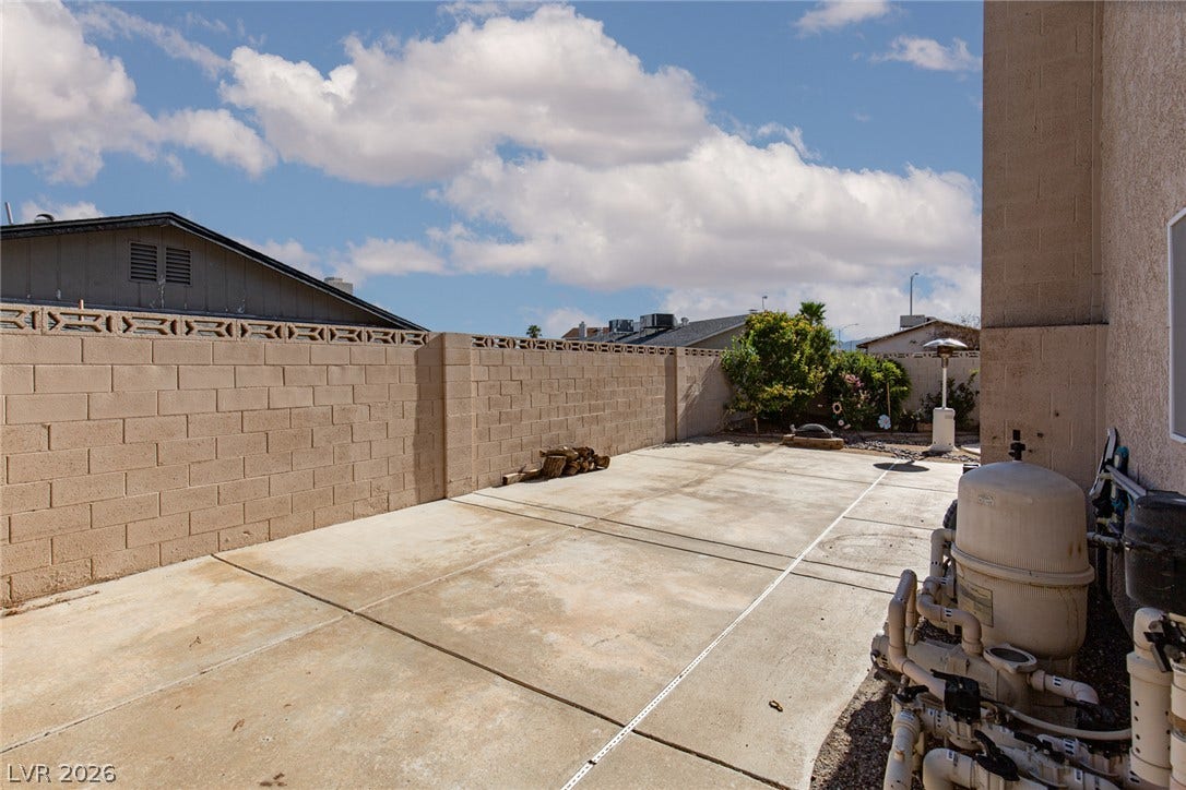 737 Brick Drive, Henderson, NV 89002 A spacious paved concrete patio is enclosed by private masonry block fencing.
