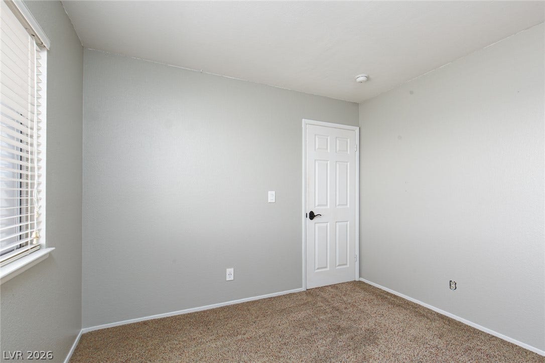 737 Brick Drive, Henderson, NV 89002 Plush carpeting and neutral-toned walls define this versatile secondary bedroom space.