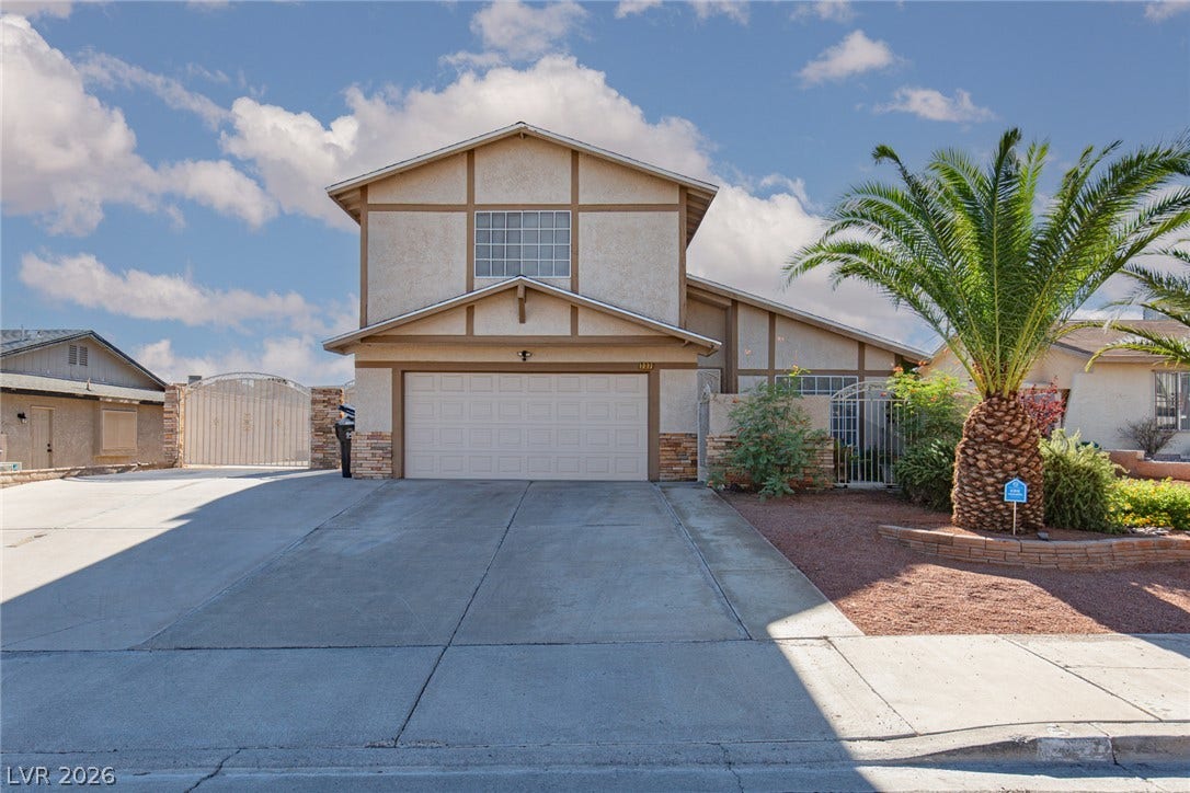 737 Brick Drive, Henderson, NV 89002 An inviting exterior displays a wide concrete driveway leading to a two-car garage.