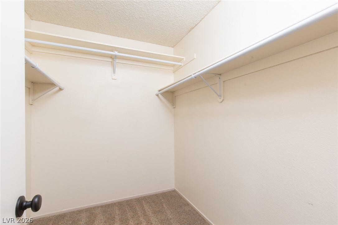737 Brick Drive, Henderson, NV 89002 Ample built-in shelving and soft carpeting define this functional storage space.