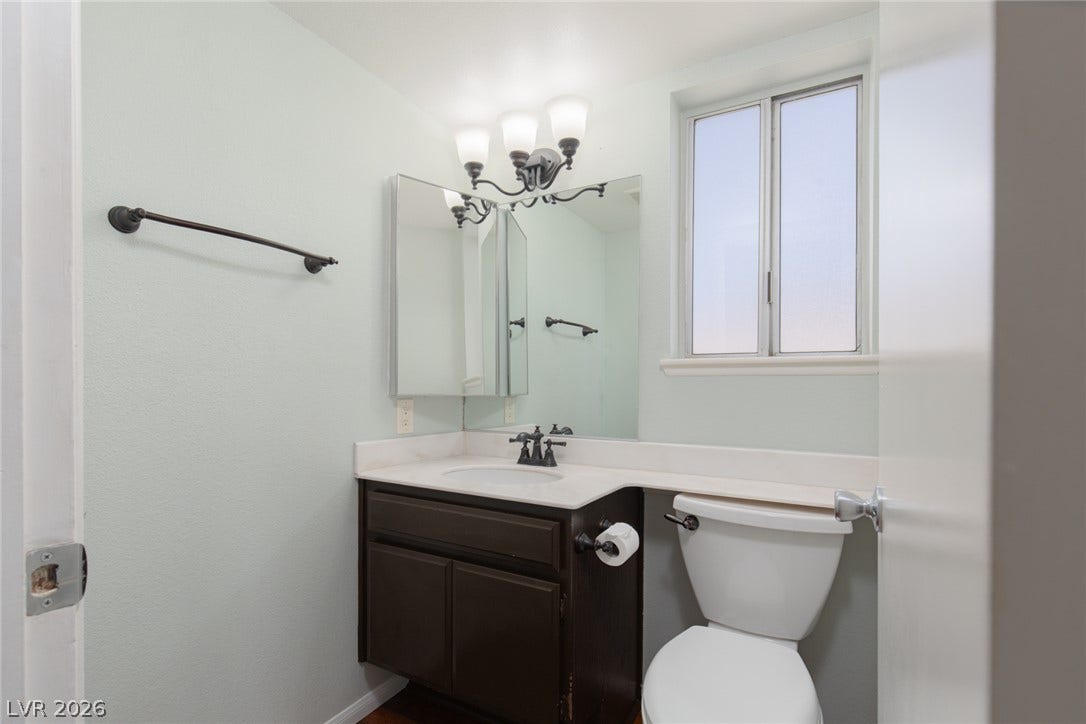 737 Brick Drive, Henderson, NV 89002 A classic vanity setup coordinates with oil-rubbed bronze hardware beneath a frosted window.