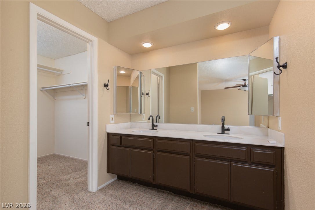 737 Brick Drive, Henderson, NV 89002 Plentiful counter space highlights this double vanity situated adjacent to a walk-in closet.