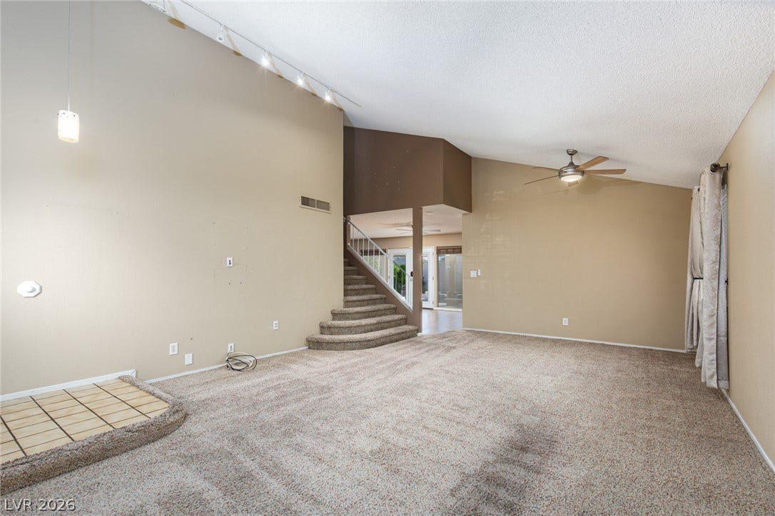 737 Brick Drive, Henderson, NV 89002 Vaulted ceilings and broad carpeted flooring anchor this versatile multi-level living area.