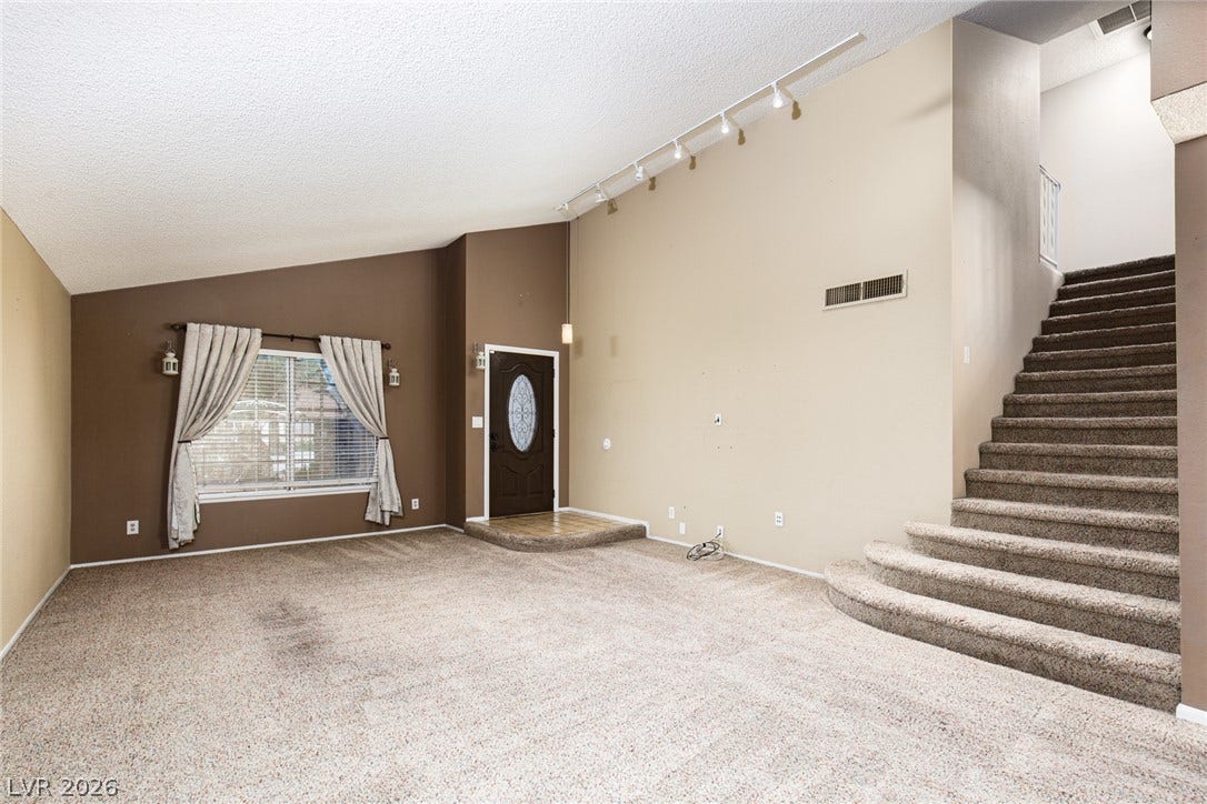 737 Brick Drive, Henderson, NV 89002 Vaulted ceilings and a wide staircase define this welcoming entry space.