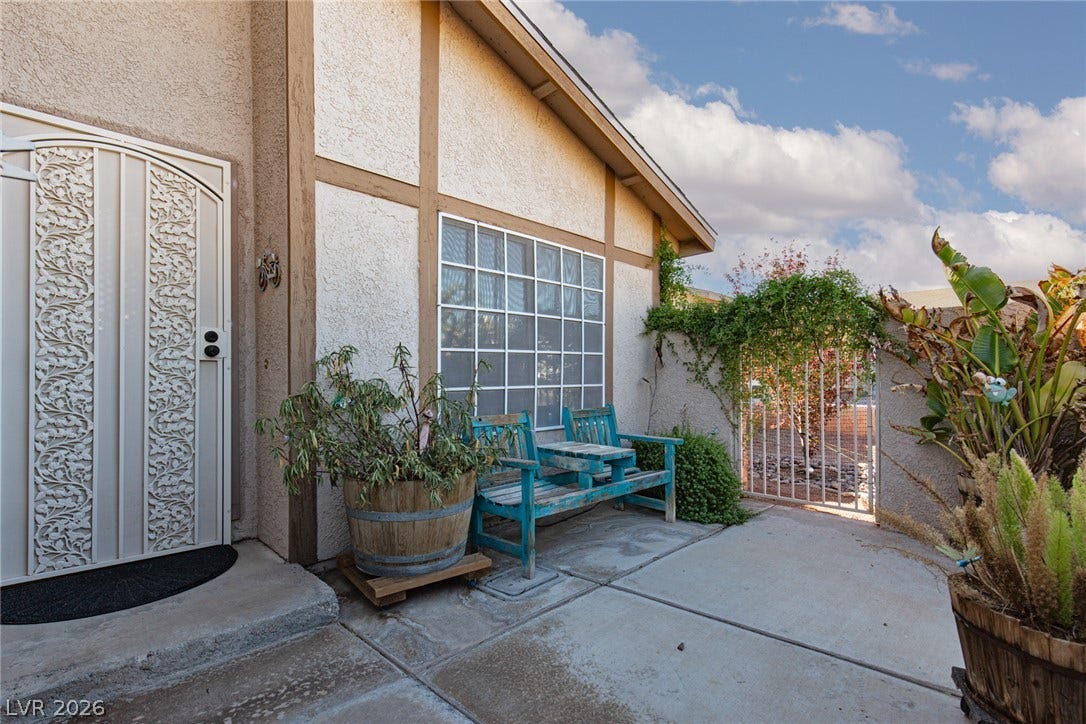 737 Brick Drive, Henderson, NV 89002 Concrete hardscaping leads to a charming entry featuring a detailed security screen door.