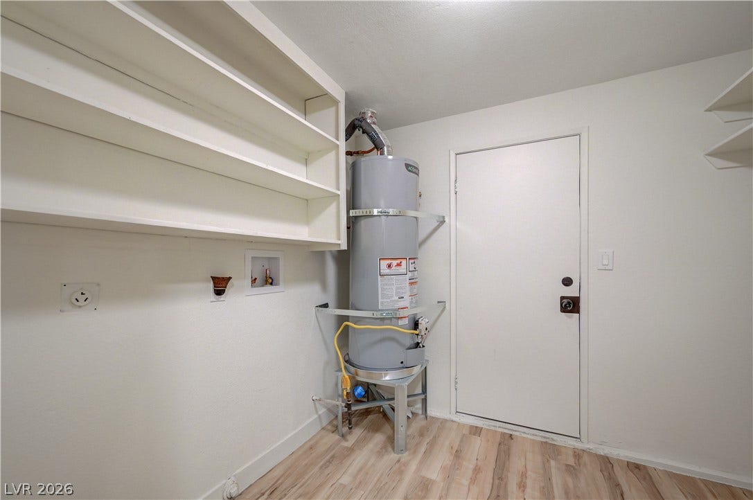 2101 Santiago Street, Las Vegas, NV 89104 Functional utility space features wood-style flooring and built-in shelving for storage convenience.