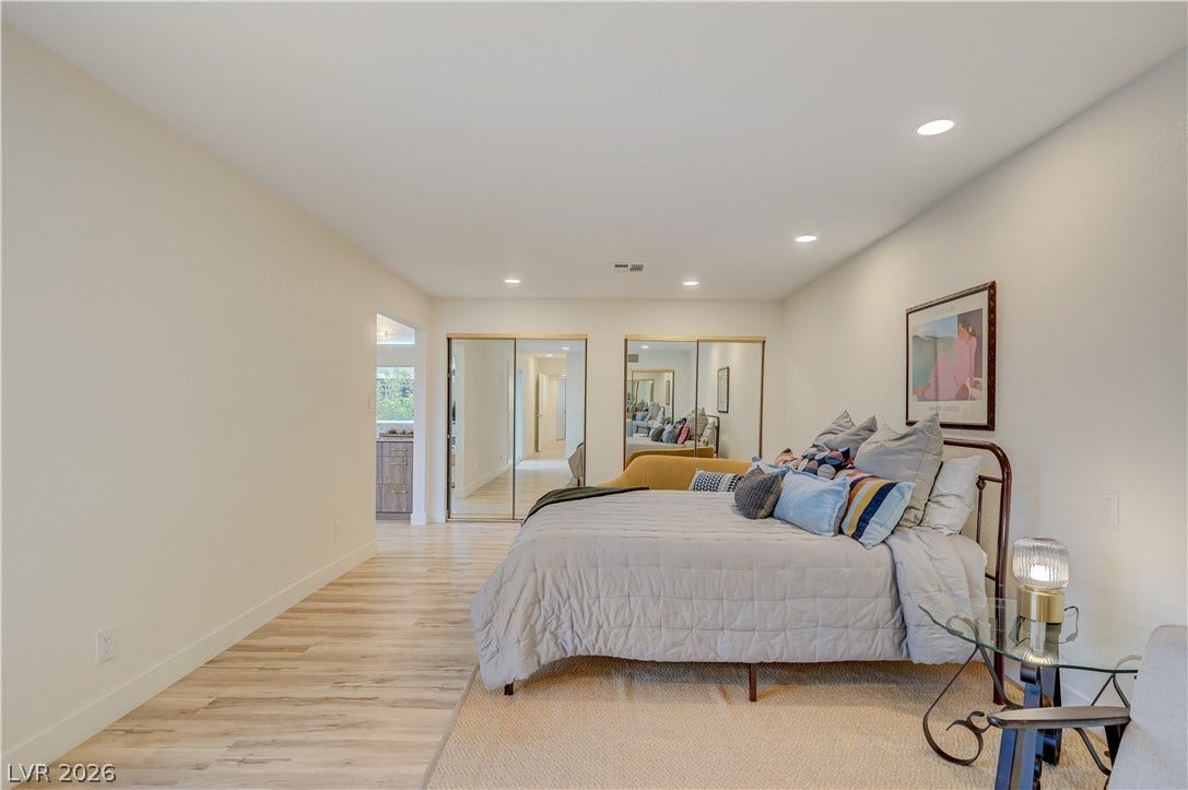 2101 Santiago Street, Las Vegas, NV 89104 Warm wood-toned floors and recessed lighting enhance this peaceful, open bedroom layout.