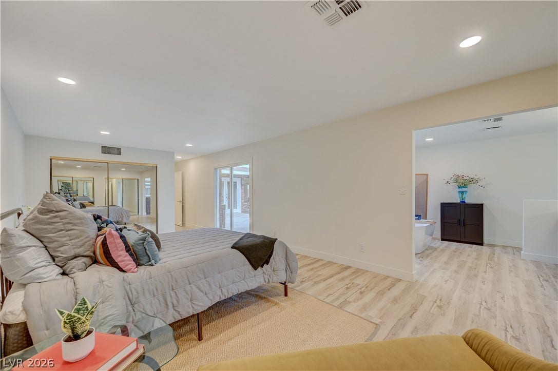 2101 Santiago Street, Las Vegas, NV 89104 Recessed lighting and light-toned flooring define this spacious primary suite with an adjacent bath area.