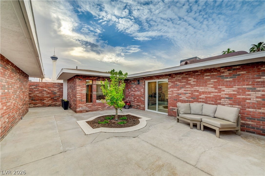 2101 Santiago Street, Las Vegas, NV 89104 A spacious concrete patio is enclosed by classic brick walls under an open sky.
