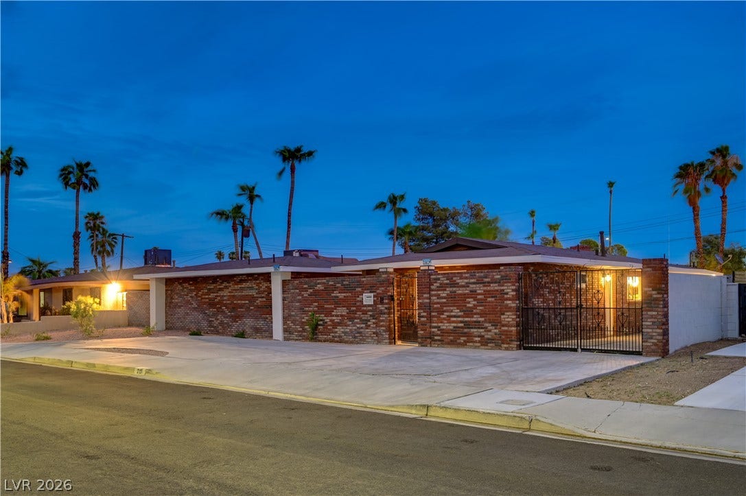 2101 Santiago Street, Las Vegas, NV 89104 Mid-century architectural lines define this brick facade property set against a desert twilight sky.