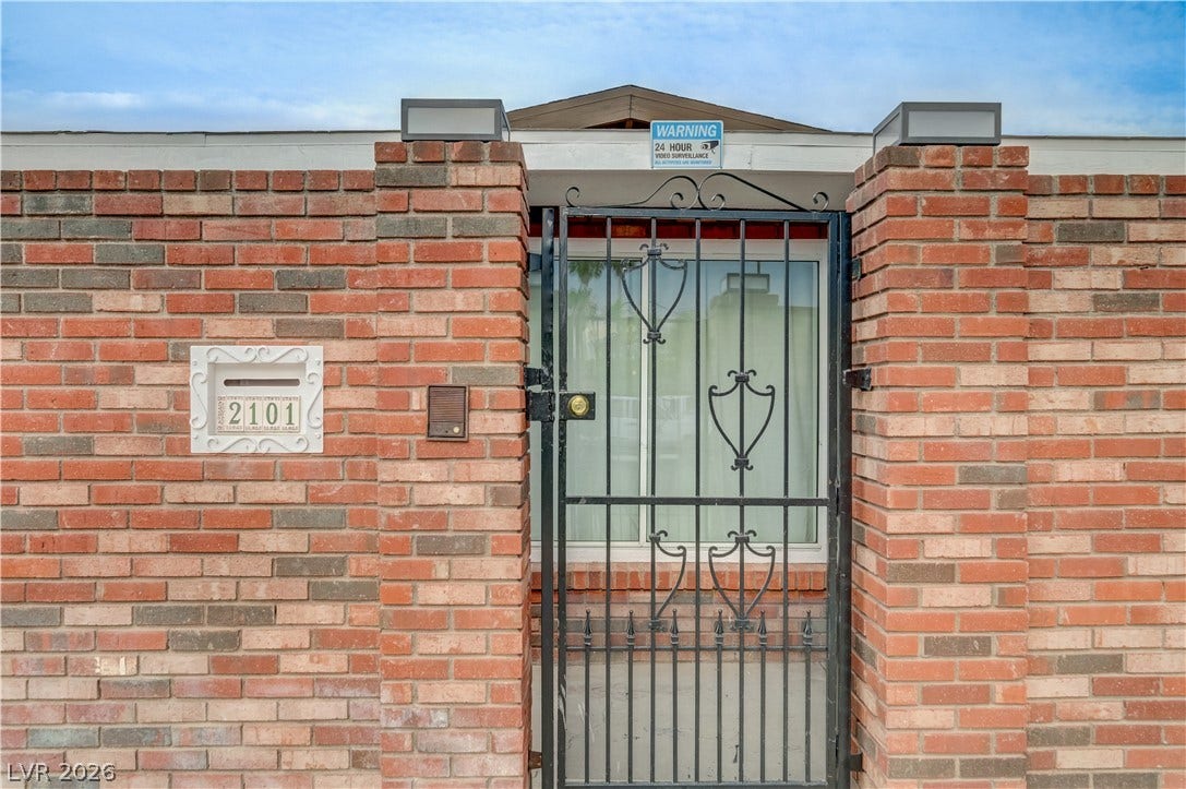 2101 Santiago Street, Las Vegas, NV 89104 Secure gated entryway framed by classic brick wall details provides a welcoming architectural statement.