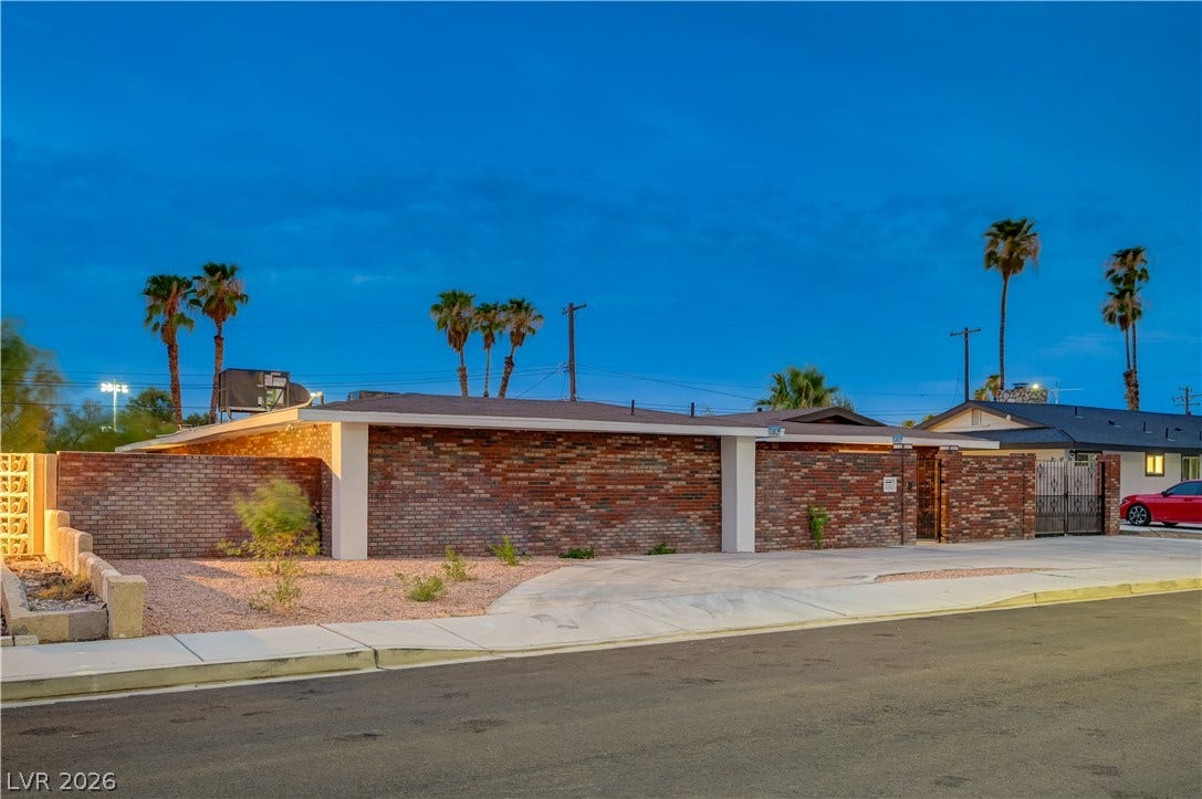 2101 Santiago Street, Las Vegas, NV 89104 Mid-century architectural lines define this striking brick facade set against a twilight desert landscape.