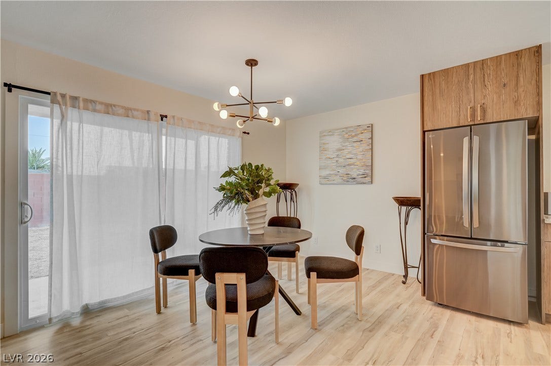 2101 Santiago Street, Las Vegas, NV 89104 Sliding glass doors open from the dining space, accented by modern light wood flooring.