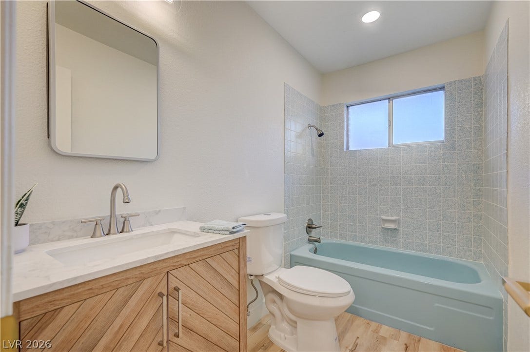 2101 Santiago Street, Las Vegas, NV 89104 Clean lines and a wood-toned vanity highlight this updated bathroom design.