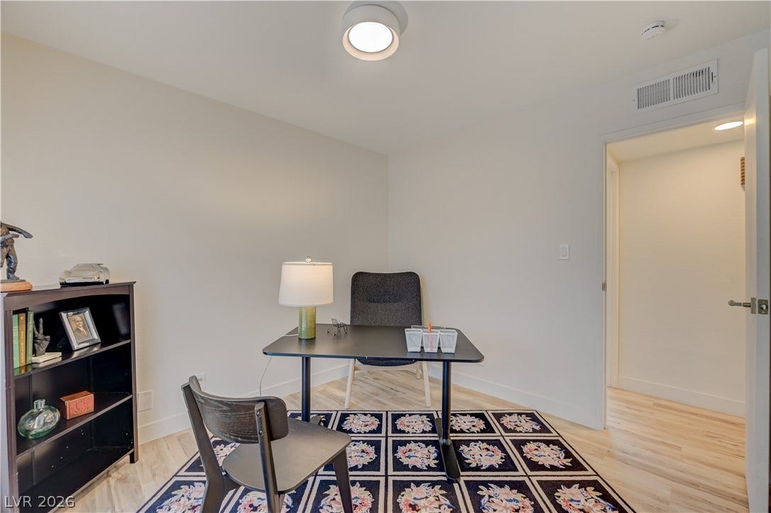 2101 Santiago Street, Las Vegas, NV 89104 Smooth plaster walls and light hardwood flooring define this quiet, versatile home workspace.