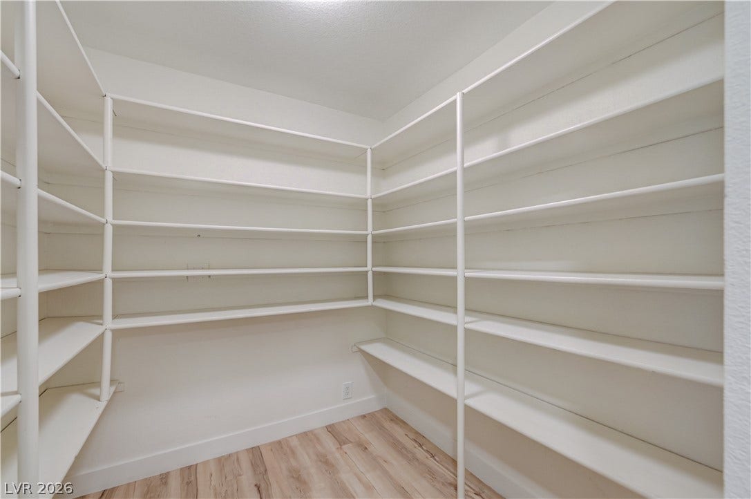 2101 Santiago Street, Las Vegas, NV 89104 Floor-to-ceiling built-in shelving maximizes storage space above durable wood-inspired flooring.