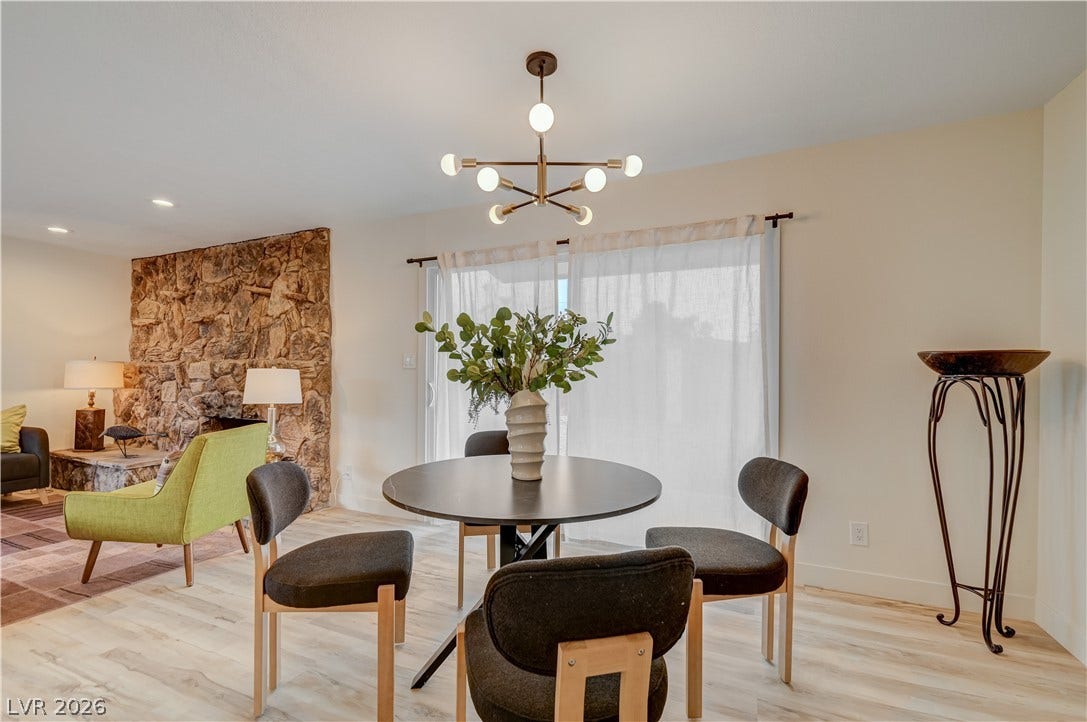 2101 Santiago Street, Las Vegas, NV 89104 Gleaming wood floors anchor a relaxed dining space set beside an impressive stone fireplace.