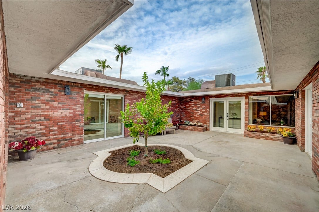 2101 Santiago Street, Las Vegas, NV 89104 Brick walls encircle a concrete courtyard under an open sky ceiling.