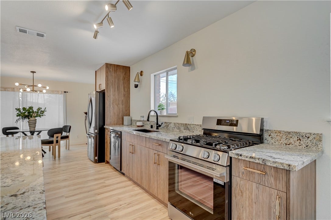2101 Santiago Street, Las Vegas, NV 89104 Granite countertops and wooden cabinets define this modern open kitchen layout.