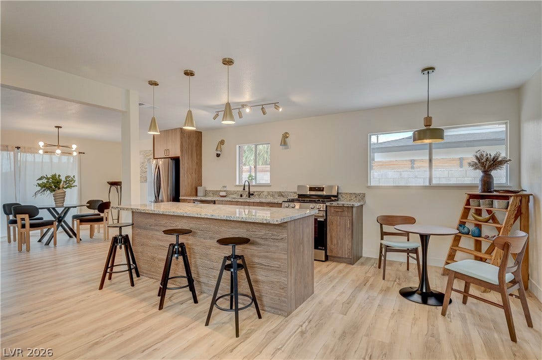 2101 Santiago Street, Las Vegas, NV 89104 Smooth wood floors anchor this open kitchen, highlighted by a stone-topped island and natural light.