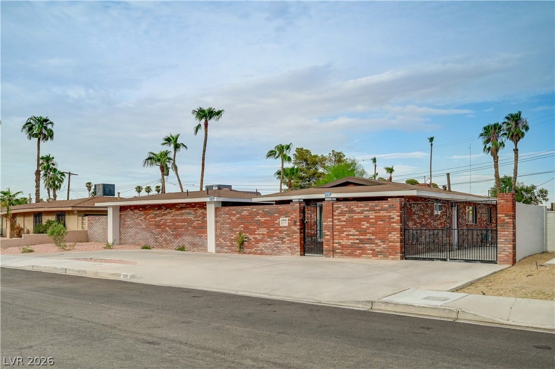2101 Santiago Street, Las Vegas, NV 89104 Midcentury brick accents and concrete parking spaces define this classic desert exterior profile.