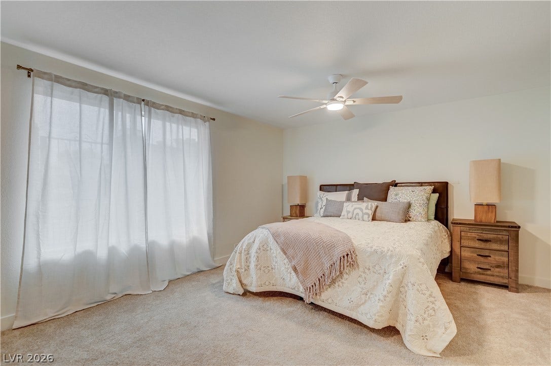 2101 Santiago Street, Las Vegas, NV 89104 Natural light pours across the carpeted floor from a large sliding glass door.