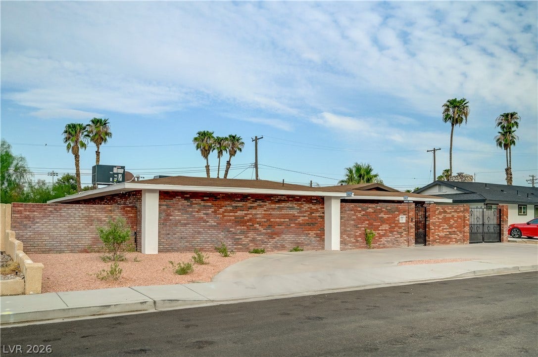 2101 Santiago Street, Las Vegas, NV 89104 A prominent brick wall highlights the street-side facade of this low-profile midcentury residence.
