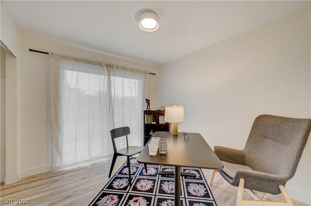 2101 Santiago Street, Las Vegas, NV 89104 Hardwood floors and a wide sliding glass door define this versatile home workspace.