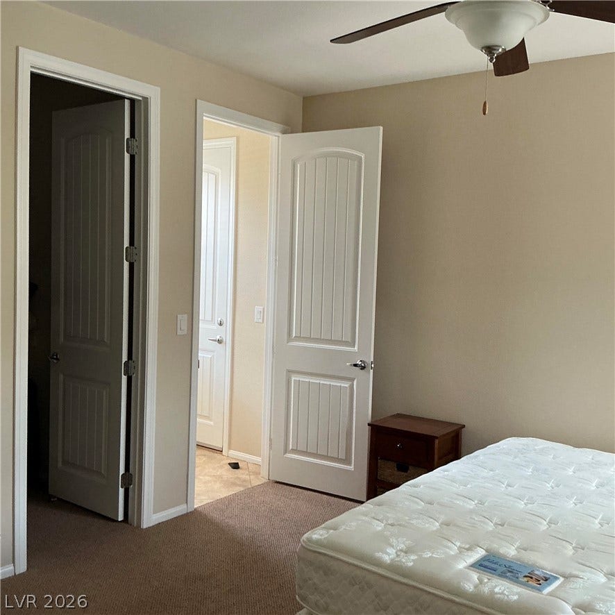 Smooth carpeting and paneled interior doors define this functional private space.
