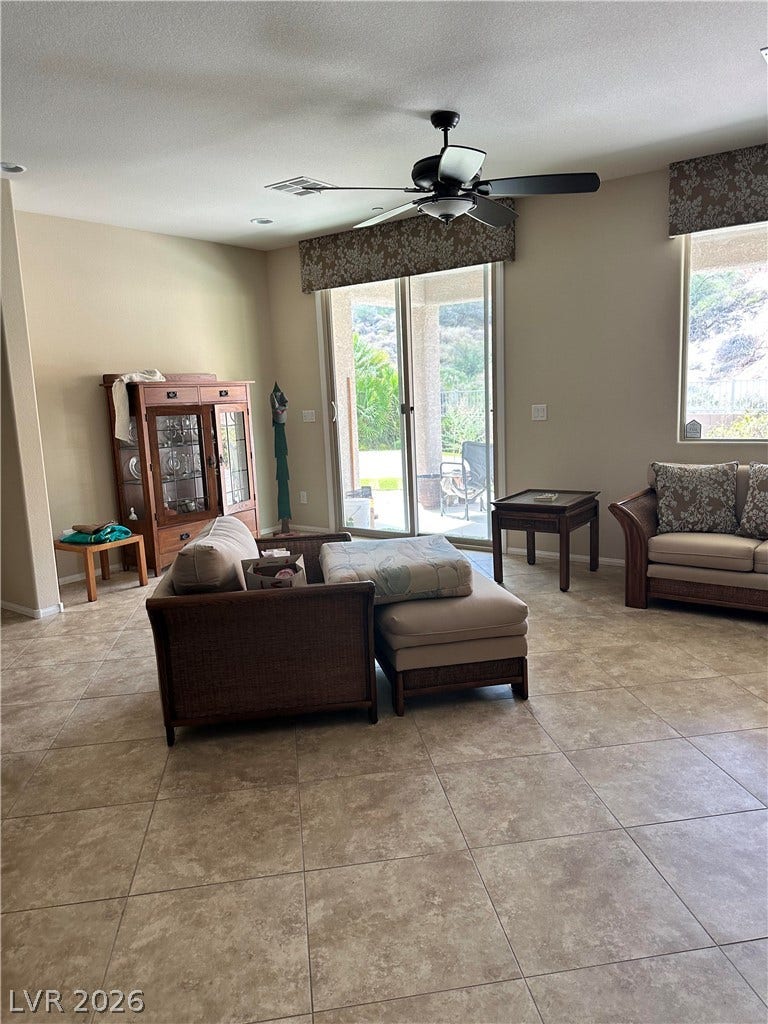 Tiled flooring and large glass doors sliding open to the backyard define this living area.