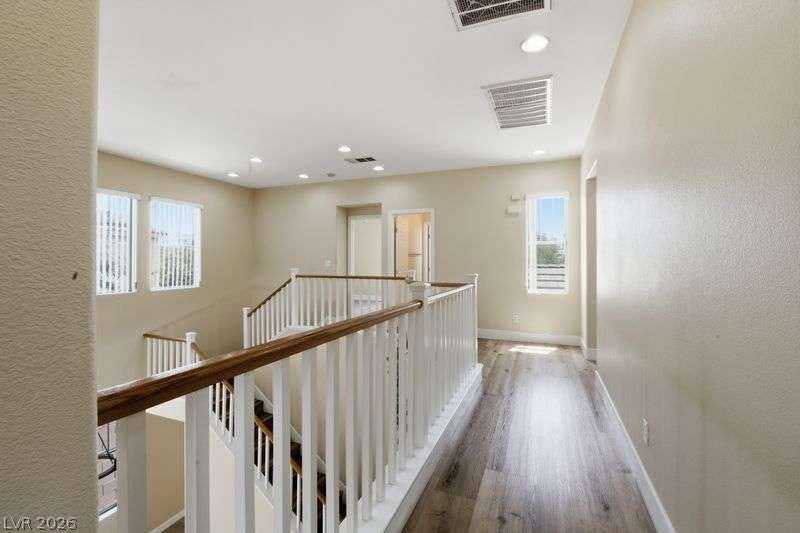 10464 Calico Pines Avenue, Las Vegas, NV 89135 A spacious upper-level landing features wood floors and open views to the staircase below.