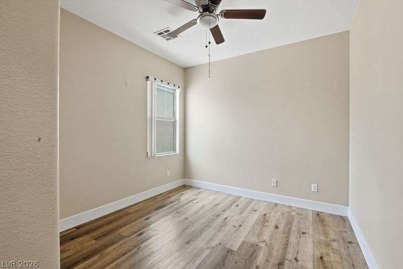 10464 Calico Pines Avenue, Las Vegas, NV 89135 Warm wood flooring and clean baseboards ground this versatile, light-filled room.