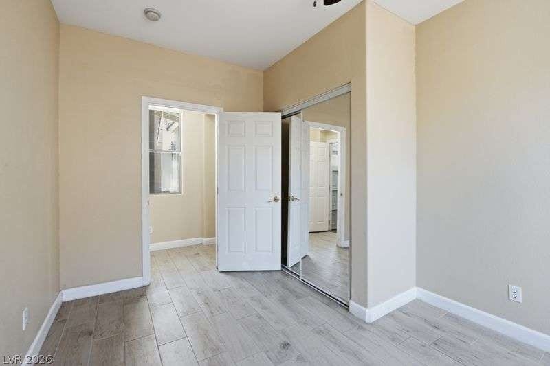 10464 Calico Pines Avenue, Las Vegas, NV 89135 Gleaming wood-look tile floors and mirrored closet doors enhance this light-filled room.