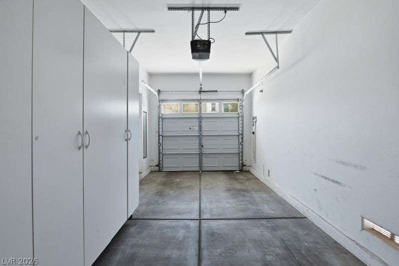 10464 Calico Pines Avenue, Las Vegas, NV 89135 Ample built-in storage cabinets line the side wall of this functional garage space.