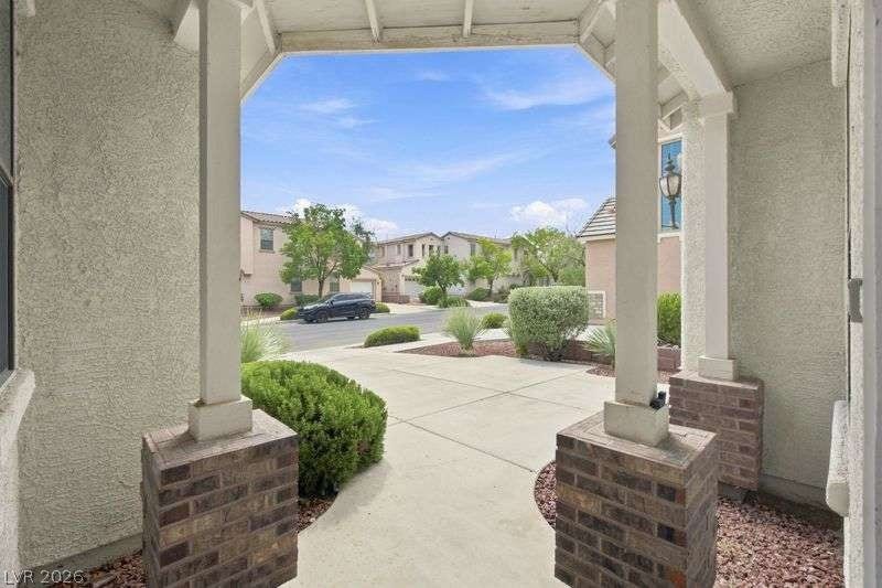10464 Calico Pines Avenue, Las Vegas, NV 89135 A covered front entryway looks out over the neighborhood pathway and drive.