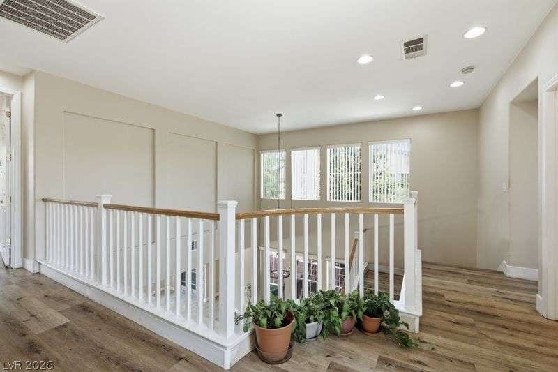 10464 Calico Pines Avenue, Las Vegas, NV 89135 Gleaming hardwood floors and a white spindle railing highlight this welcoming upper-level landing.