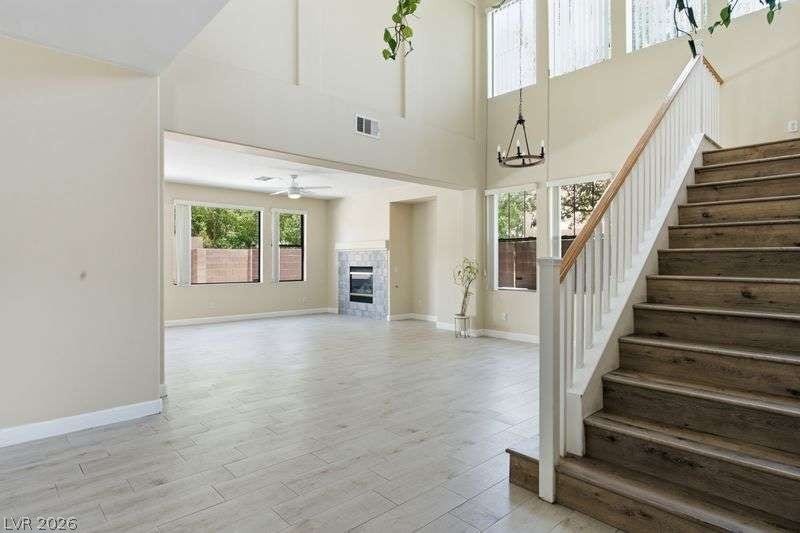 10464 Calico Pines Avenue, Las Vegas, NV 89135 Soaring ceilings and custom flooring define this open-concept entryway featuring a dramatic wooden staircase.