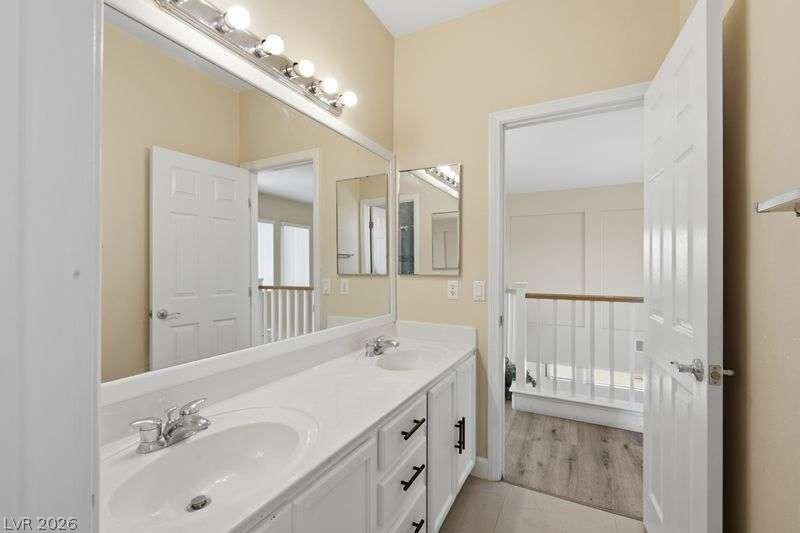 10464 Calico Pines Avenue, Las Vegas, NV 89135 Double sinks with chrome faucets set into a spacious vanity enhance this bright bathroom.