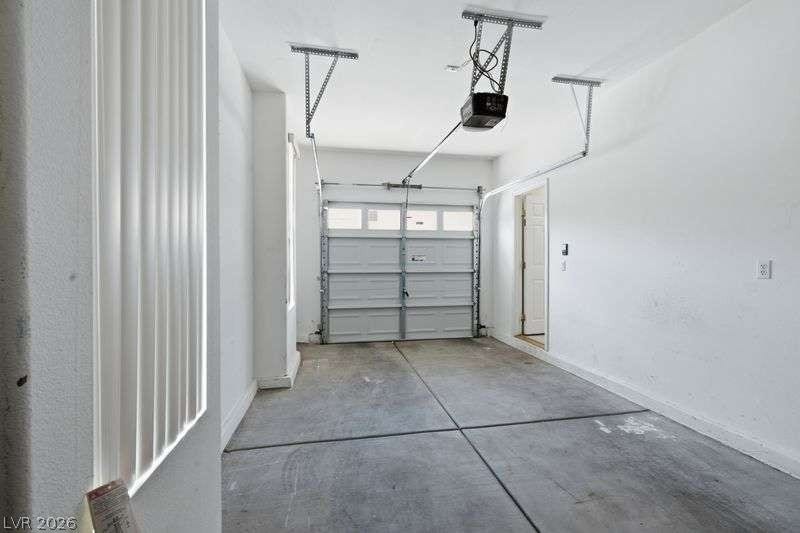 10464 Calico Pines Avenue, Las Vegas, NV 89135 Concrete flooring and high ceilings define this functional garage space with direct interior entry.