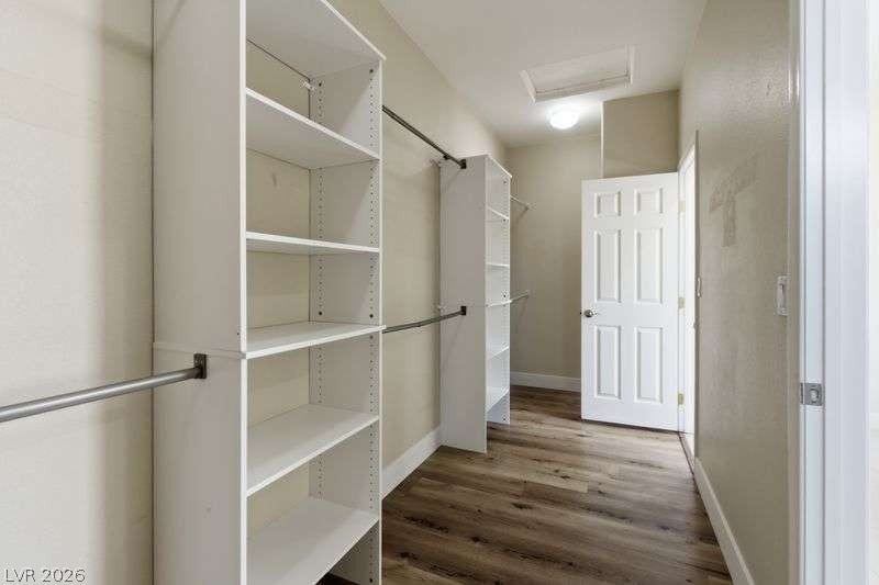 10464 Calico Pines Avenue, Las Vegas, NV 89135 Custom built-in shelving and ample hanging rods maximize organization in this closet.