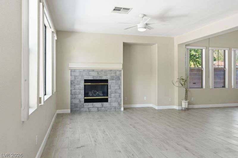 10464 Calico Pines Avenue, Las Vegas, NV 89135 Plank flooring and a classic stone fireplace define this comfortable living area.